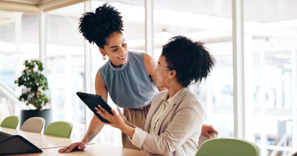 Two black women entrepreneurs collaborating and coworking.