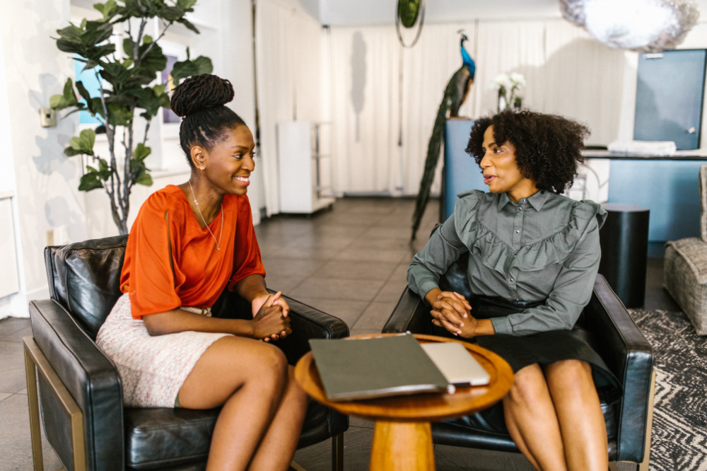 Black women entrepreneurs sharing feedback and discussing business strategies.