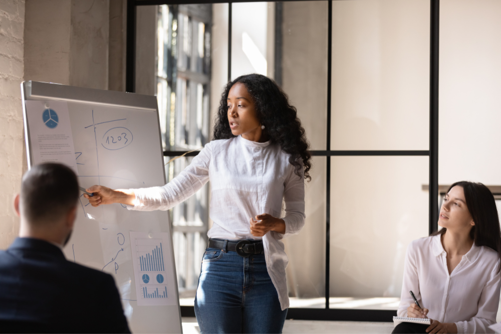 Black woman entrepreneur analyzing business metrics during a pitch preparation